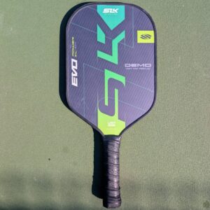 Selkirk SLK Evo Power pickleball paddle, 13mm, green and teal, XL shape, on a pickleball court