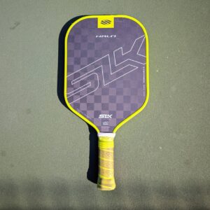 Selkirk SLK Halo Control pickleball paddle, 16mm, yellow trim, on a pickleball court