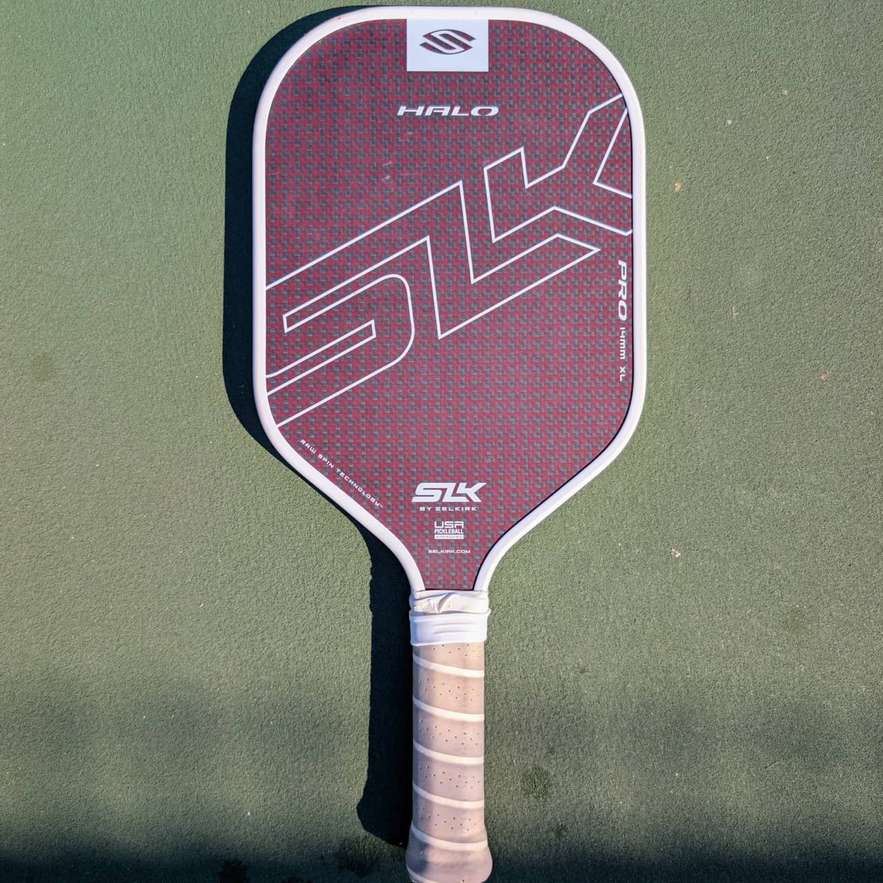 Selkirk SLK Halo Pro pickleball paddle, 14mm, maroon, XL shape, on a pickleball court